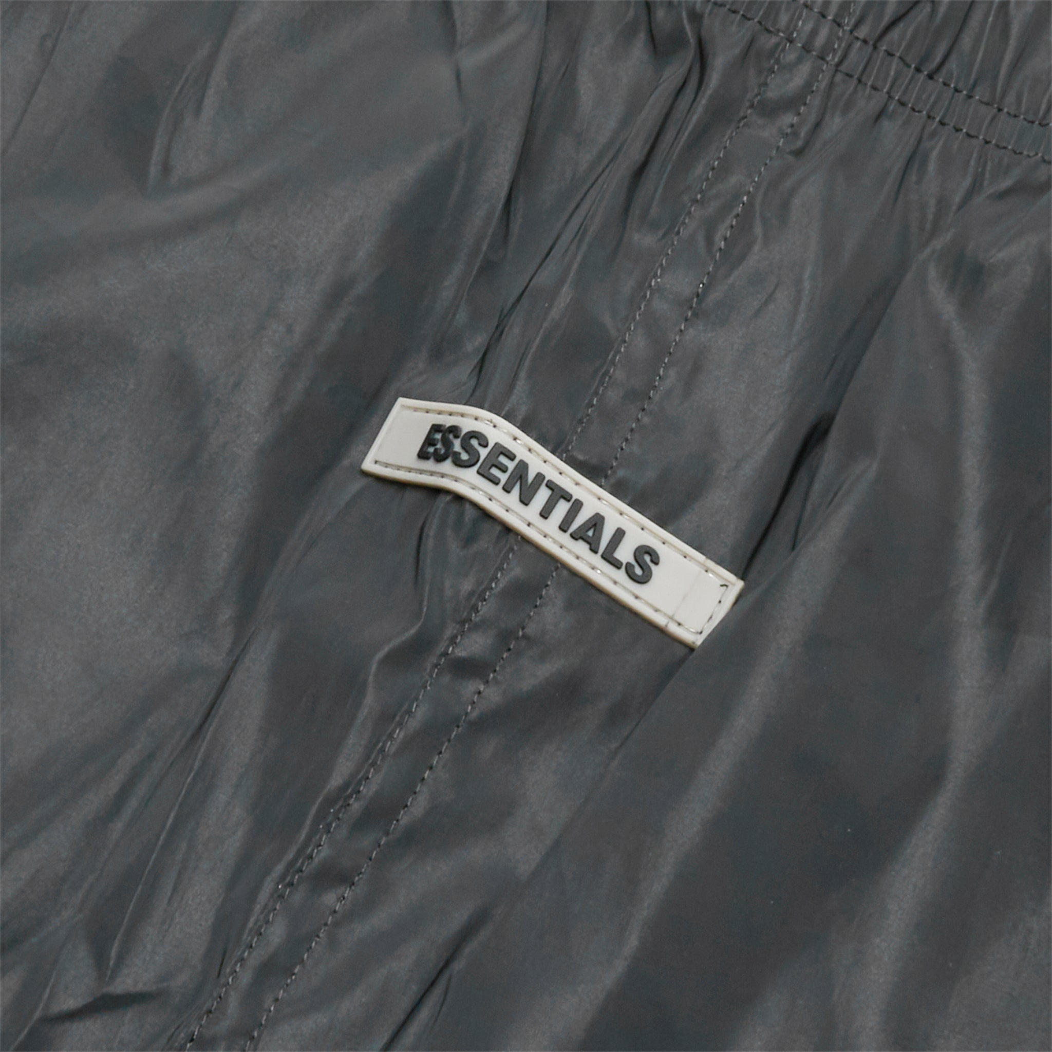 Front logo view of Preloved - Fear Of God Essentials Black Reflective Nylon Track Pants